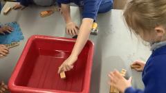 Children testing objects for floating and sinking