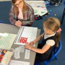 Mum completing maths activity with child