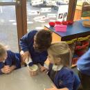 Children measuring salt into a cup