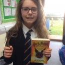 Willow class pupil dressed up as a wizard holding a Harry Potter book