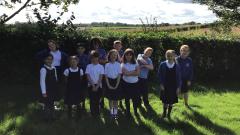 Silver birch children smiling outside on the grass