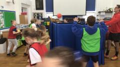 Children in their PE lesson taking part in a game called ‘popcorn’