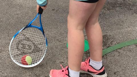 Ball skills using a tennis racquet and ball. 