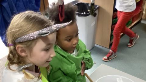 children mixing objects, pretending it is a potion