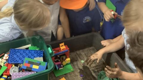 Children building a house from Lego