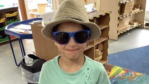 Child wearing sun hat and sunglasses 