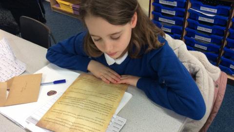 Girl reading old fashioned paper