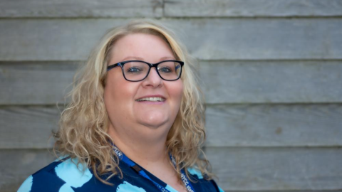 Headteacher in sky blue and navy spotted dress