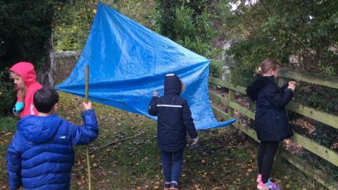 Children building a den