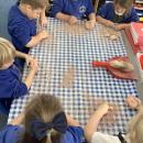 children chipping away at a salt dough shaped egg