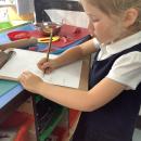 Girl writing on a clipboard 