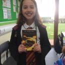 Willow class pupil dressed up as a wizard holding a Harry Potter book