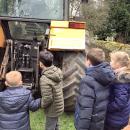 Children looking at the back of a tractor