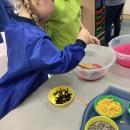 children mixing jelly, pretending it is a potion