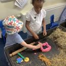 Children building a playdough house