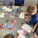 Children cutting and sticking coloured paper