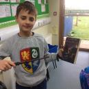 Willow class pupil dressed up as a wizard holding a Harry Potter book