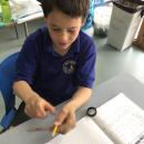 Fraser exploring who a rubber band attached to a ruler vibrates