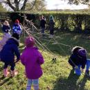 Children using sticks to build a den