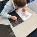 The children experiencing what it would have been like to write with chalk!