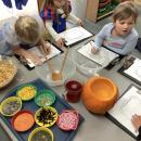 children writing a list of ingredients for a potion