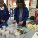 Adding salt to a tomato.