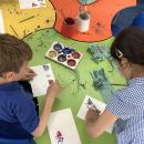 Children printing with shapes and paint