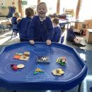 Child sorting shapes into different categories 
