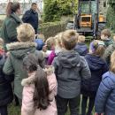 Children looking at the front of a tractor