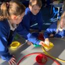 Children sorting seeds into pots