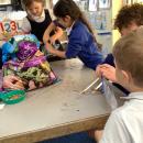 Children planting seeds in zip lock bags