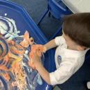Child exploring foam and paint