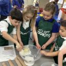The children are weighing out the ingredients for making shortbread