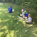 Children reading books outside