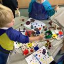 child printing on paper with conkers